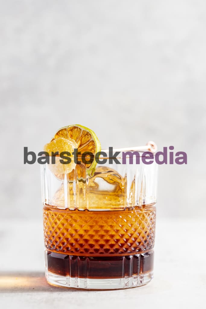 Rum Old Fashioned With Lime And Candied Ginger Garnish Photo